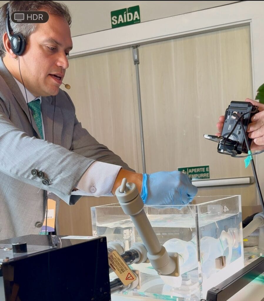 man demonstrating insertion of the tricvalve system at LATAM Valves event