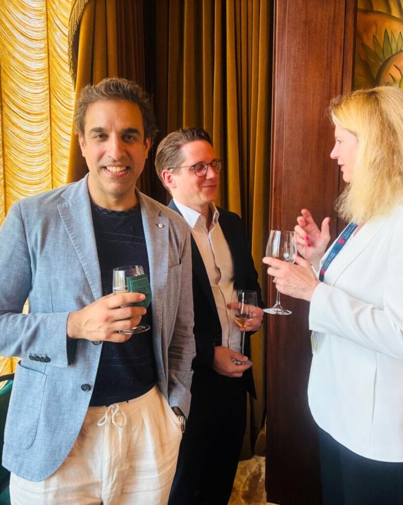 Elegant business networking event with professionals enjoying drinks and engaging conversation.