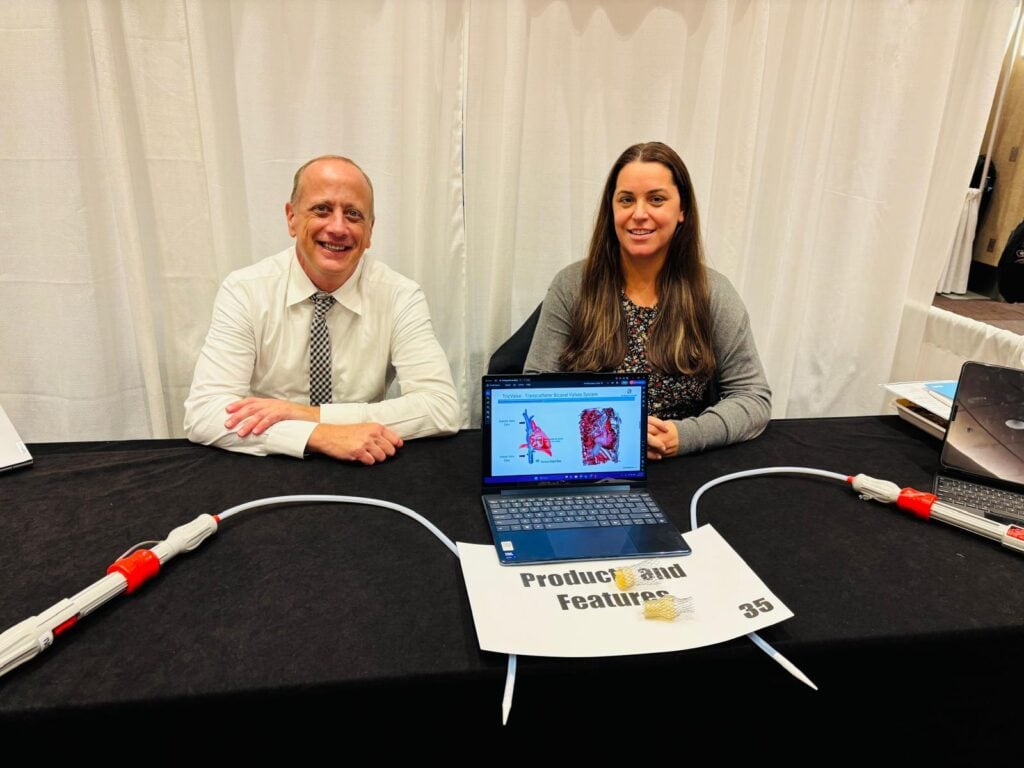Two people sitting at a table for products and features at HFSA Annual Scientific Meeting 2025